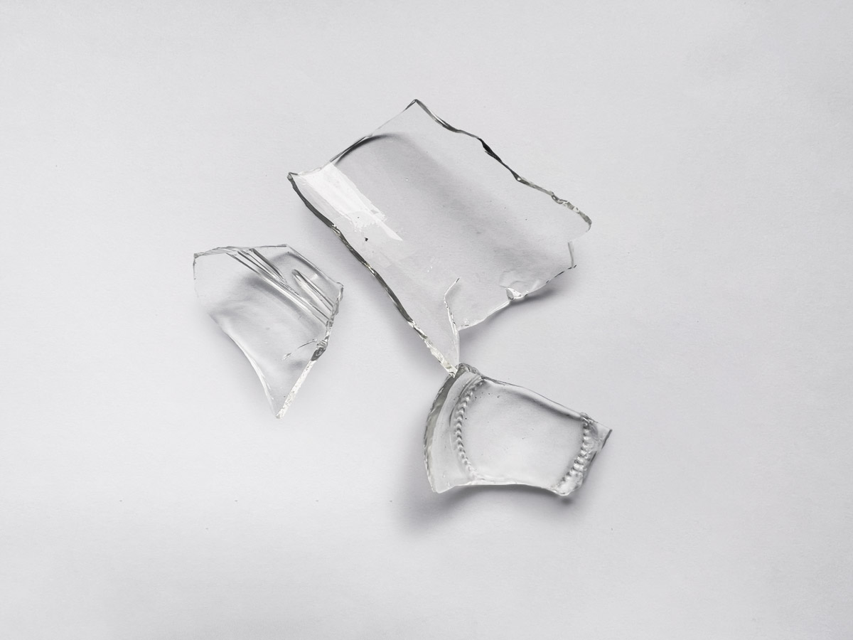 Broken glass pieces. Shattered glass on white background. Vector